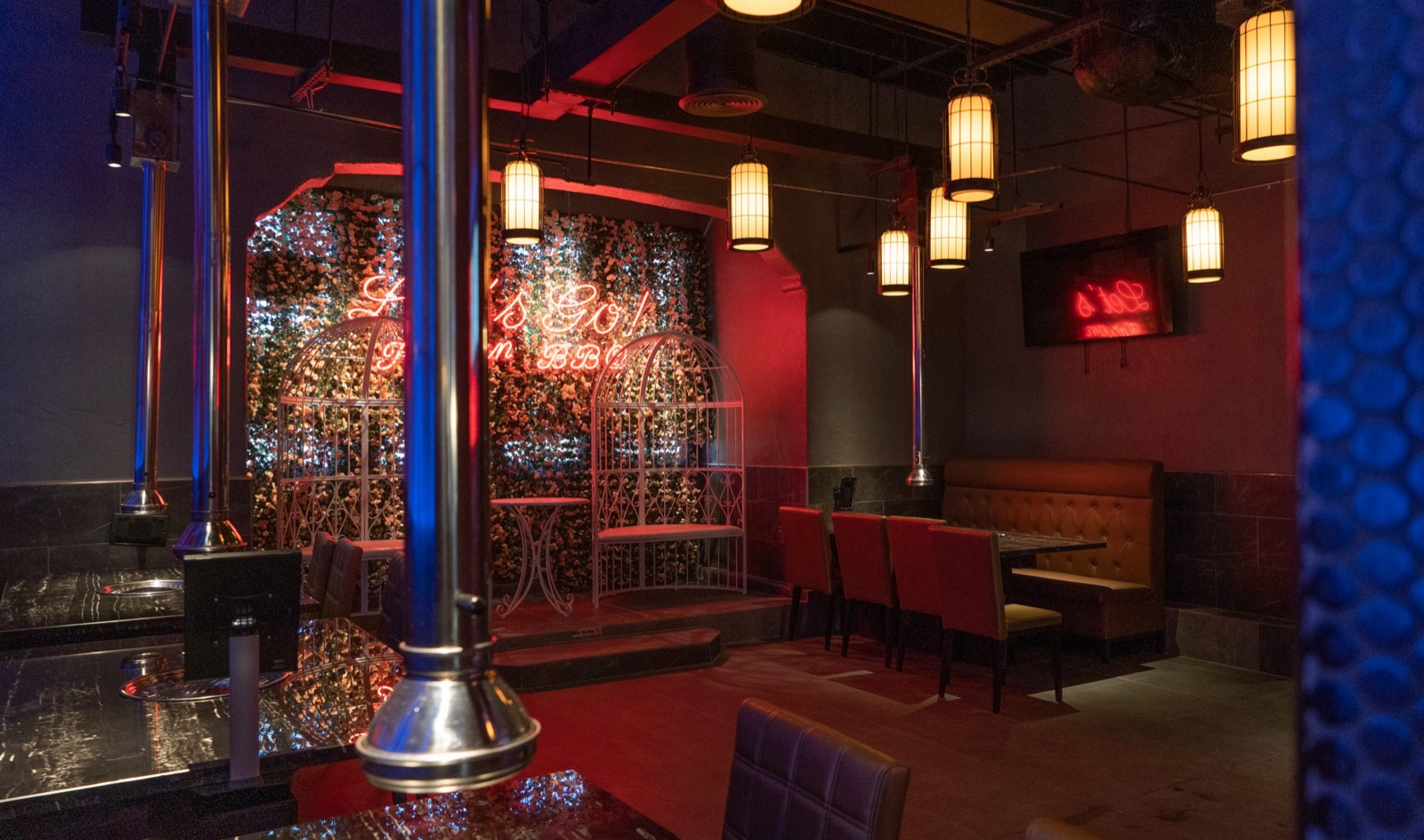 Interior view of Gaja Korean BBQ with neon signs and booth seating