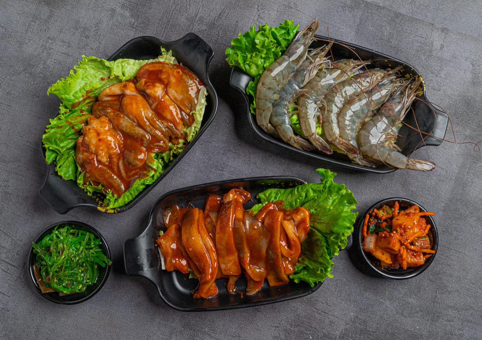 Marinated chicken shrimp and Korean side dishes at Gaja BBQ Oceanside